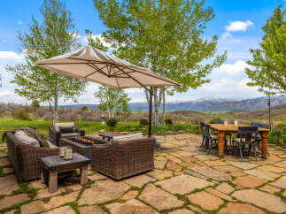 Enjoy the ultimate outdoor living experience with this stunning property! Featuring a beautifully designed patio with a cozy fire pit, comfortable seating, and a stylish dining area, perfect for entertaining or relaxing.