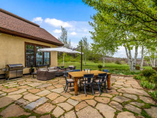 Enjoy outdoor living at its finest with this stunning property featuring a spacious patio and a gourmet grill.