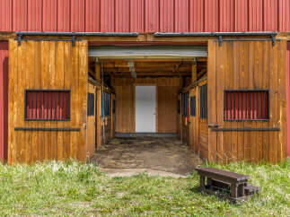 This charming barn-style property offers a unique blend of rustic charm and modern convenience.