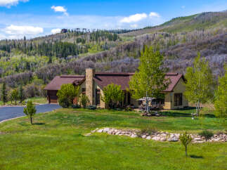 This stunning property boasts a beautiful home nestled in a picturesque mountain setting.