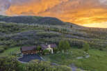 Experience breathtaking mountain living in this stunning home, nestled amidst lush greenery and rolling hills.