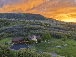 Experience breathtaking mountain living in this stunning home, nestled amidst lush greenery and rolling hills.