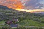 Experience breathtaking mountain living with this stunning property nestled amidst rolling hills and vibrant aspen groves.