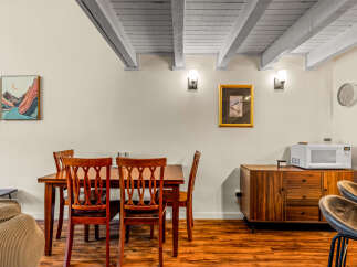 This charming dining area features a beautiful wooden dining table and chairs, perfect for family meals or entertaining guests.