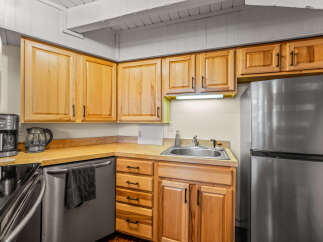This charming kitchen boasts beautiful wooden cabinetry, offering ample storage space for all your culinary essentials.