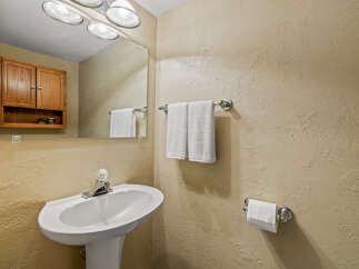 This charming bathroom features a pedestal sink, perfect for maximizing space.