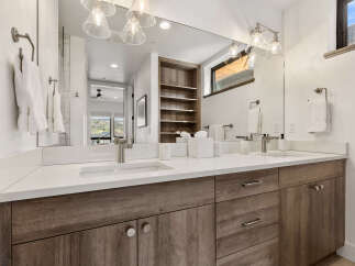 This stunning bathroom features a modern design with a double vanity, offering ample space and functionality.