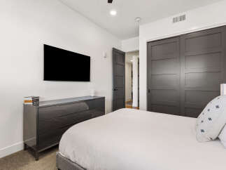 This modern bedroom boasts a sleek, contemporary design with a focus on comfort and style.