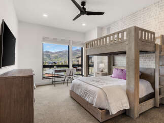 This stunning bedroom features a unique bunk bed design, perfect for maximizing space and adding a touch of modern flair.