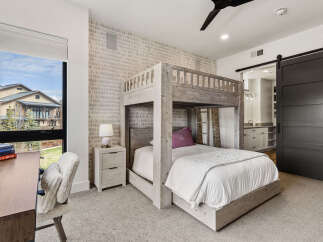 This stunning bedroom boasts a unique bunk bed design, perfect for maximizing space and adding a touch of modern flair.