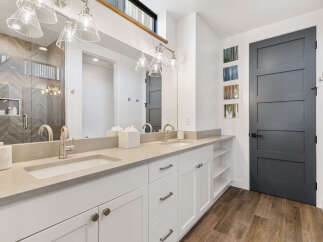 This modern bathroom features a sleek vanity with dual sinks and ample storage.