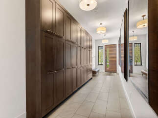 Step into luxury with this stunning entryway featuring custom cabinetry and elegant design.