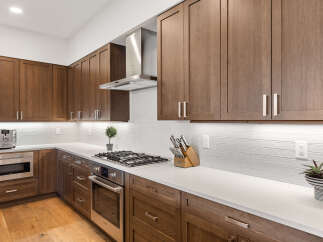 This stunning kitchen boasts custom cabinetry, offering ample storage and a warm, inviting atmosphere.