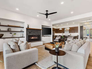 Experience luxury living in this stunning property, featuring a cozy fireplace and a modern open-concept design.