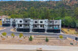 Discover modern living in this stunning townhouse development nestled against a scenic hillside.