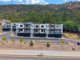 Discover modern living in this stunning townhouse development nestled against a scenic hillside.