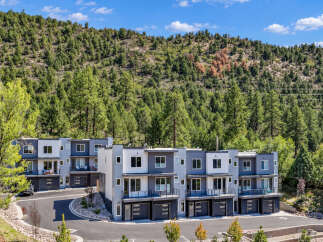 Discover modern living in this stunning townhome development nestled against a lush, tree-covered mountainside.