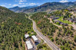 Discover this stunning aerial view showcasing a modern residential complex nestled amidst a picturesque mountain landscape.