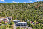 Discover modern living nestled against a backdrop of lush green hills.
