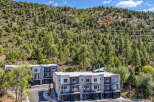 Discover modern living in this stunning townhouse complex nestled against a backdrop of lush green hills.