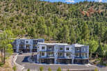 Discover modern living in this stunning townhouse complex nestled against a backdrop of lush green hills.