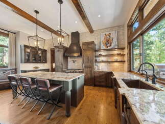 This stunning kitchen boasts a rustic yet modern design, perfect for culinary enthusiasts.