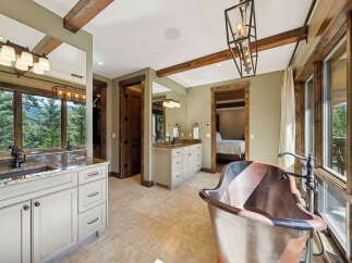 Indulge in luxury within this stunning bathroom, featuring a copper bathtub and elegant fixtures.