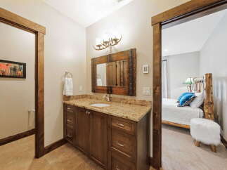 This stunning bathroom boasts a rustic, yet elegant design.