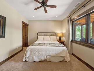 This inviting bedroom features a cozy ambiance with its neutral color palette and plush carpeting.