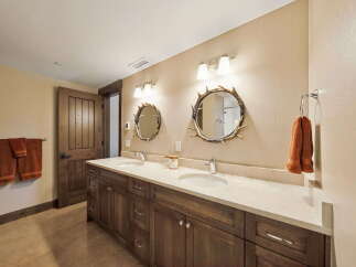 This stunning bathroom boasts a rustic yet elegant design, perfect for a luxurious retreat.