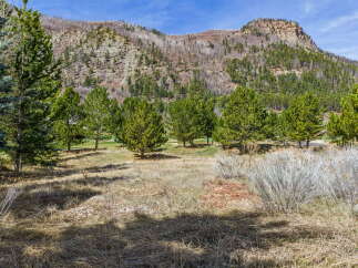 Discover the tranquility of this stunning property nestled amidst a picturesque mountain landscape.