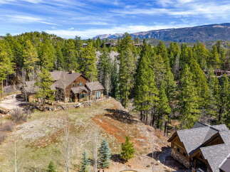 Nestled amidst a lush forest, this stunning property offers unparalleled privacy and breathtaking mountain views.