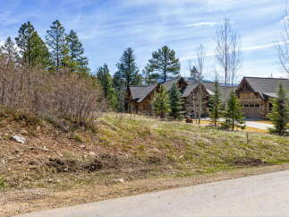 Nestled amidst the serene beauty of nature, this stunning property boasts a charming wooden exterior and a picturesque setting.