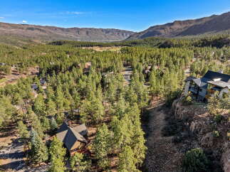 Nestled amidst a lush forest and offering breathtaking mountain views, this stunning property is a true sanctuary.