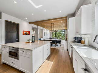 Step into luxury with this stunning kitchen, featuring a spacious island and modern appliances.
