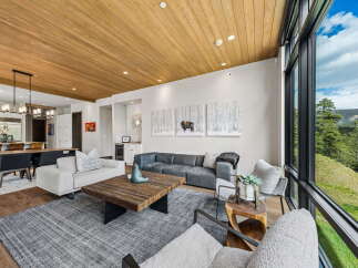 Experience luxury living in this stunning property, featuring a spacious living area with a cozy fireplace and large windows.