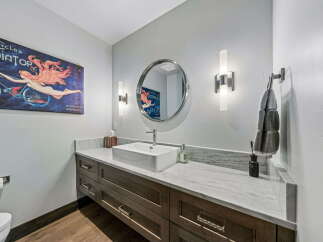 This stunning bathroom boasts a modern design with a touch of vintage charm.