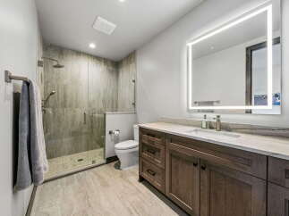 Step into luxury with this stunning bathroom! Featuring a sleek, modern design, this space boasts a spacious walk-in shower, elegant vanity, and a well-lit mirror.