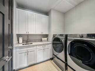 This stunning laundry room boasts modern design and functionality.