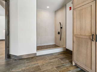 Step into luxury with this stunning property featuring a modern walk-in shower.