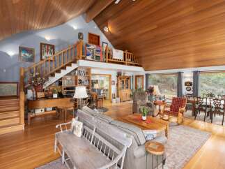This stunning property boasts a spacious and inviting interior with a warm, wooden ceiling that adds a touch of rustic elegance.