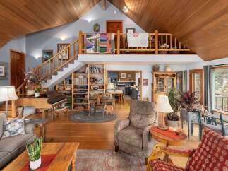 This stunning property boasts a spacious, open-concept living area with a unique loft space.