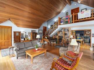 Step into this stunning home featuring a unique design with a loft and a grand piano.