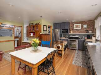 This charming kitchen boasts a unique blend of rustic and modern elements, perfect for those who appreciate character and functionality.