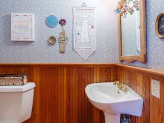 This charming bathroom features a unique blend of vintage decor and functional design.