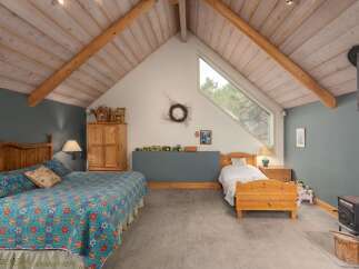 This charming bedroom features a cozy and inviting atmosphere, perfect for relaxation.