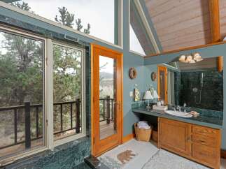 This stunning bathroom boasts a unique blend of rustic charm and modern elegance.
