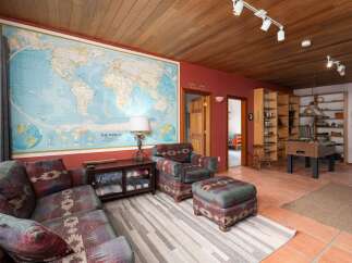 This inviting living space features a unique world map wall decor, creating a focal point that sparks curiosity and wanderlust.