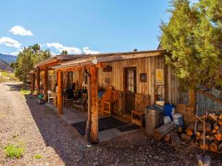 This charming cabin offers a rustic retreat with a welcoming porch and a cozy atmosphere.