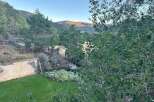Discover a charming property nestled amidst rolling hills and mature trees, offering a serene escape.
